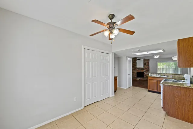 a view of a livingroom with a chandelier furniture and a ceiling fan