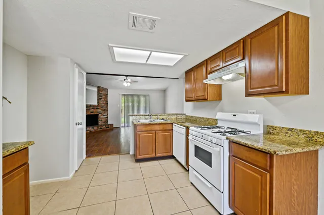 a kitchen with a stove sink and a refrigerator