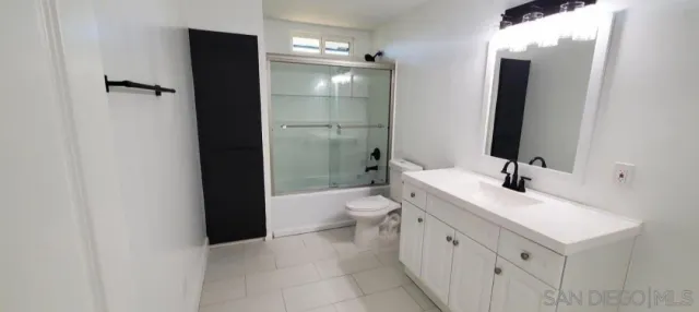 a bathroom with a bathtub sink toilet and a mirror