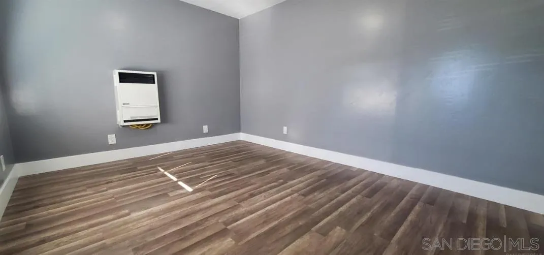 2743-2745 Ridgeway Drive National City, CA 91950 - Photo 26 of 35 a view of a room with wooden floor and white walls
