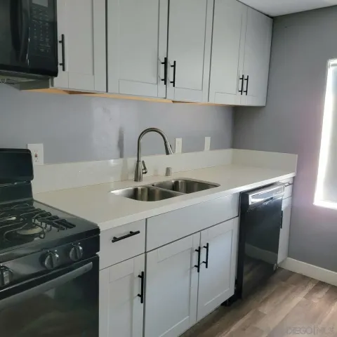 a kitchen with cabinets appliances and a sink