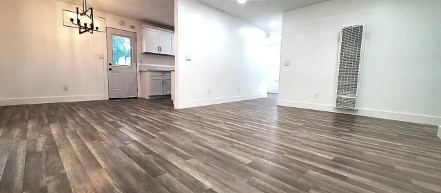 a view of a kitchen with wooden floor and a sink