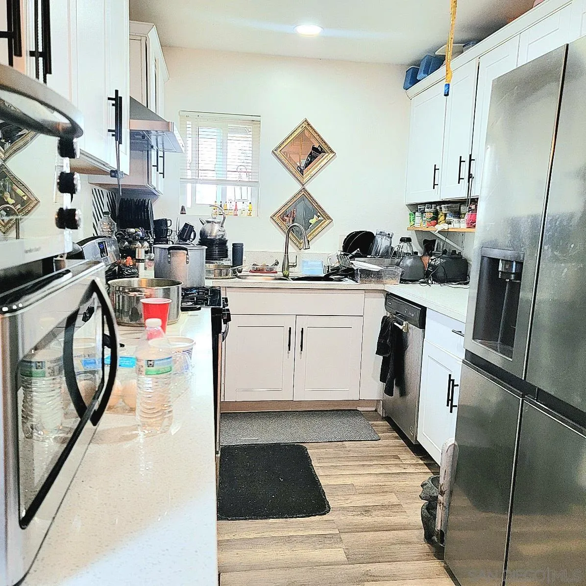 2743-2745 Ridgeway Drive National City, CA 91950 - Photo 7 of 35 a kitchen with a sink stainless steel appliances and white cabinets