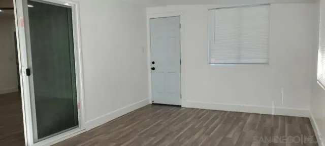 a view of a small space with wooden floor and closet