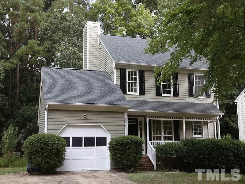6108 New Market Way Raleigh, NC 27609 - Photo 1 of 17 a front view of a house with a yard and garage