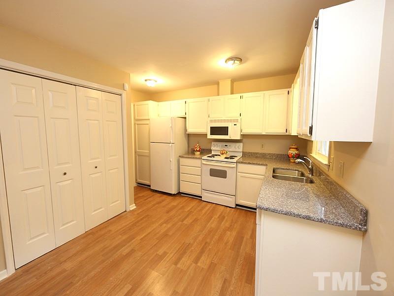 6108 New Market Way Raleigh, NC 27609 - Photo 2 of 17 a kitchen with stainless steel appliances granite countertop a stove a sink and a refrigerator