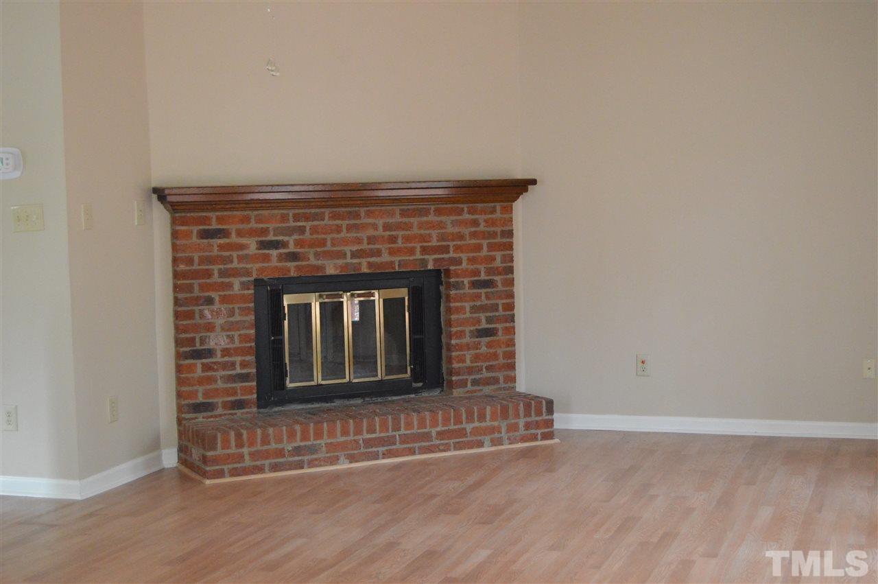 6108 New Market Way Raleigh, NC 27609 - Photo 6 of 17 an empty room with fireplace