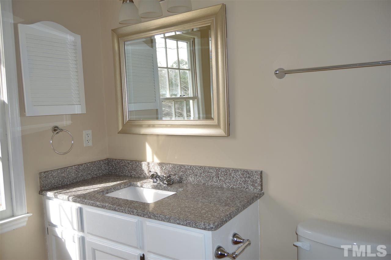6108 New Market Way Raleigh, NC 27609 - Photo 10 of 17 a bathroom with a granite countertop sink and a mirror