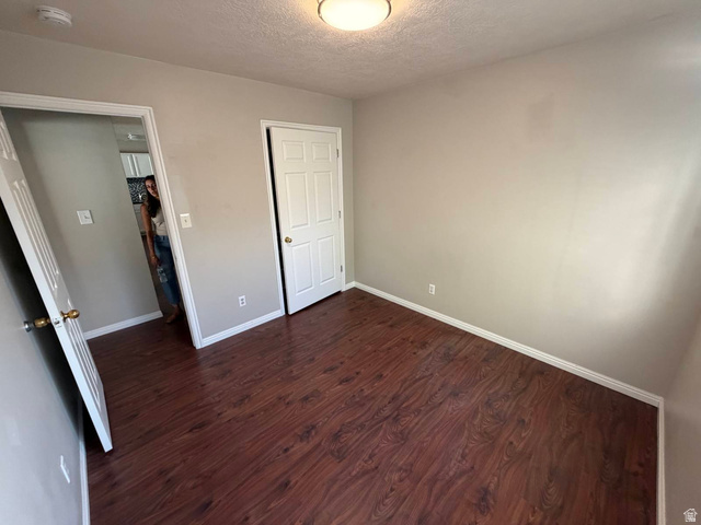 1563 South 600 East Springville, UT 84663 - Photo 6 of 30 Room featuring wood-finish flooring, neutral wall paint, white trim, and a flush-mount ceiling light