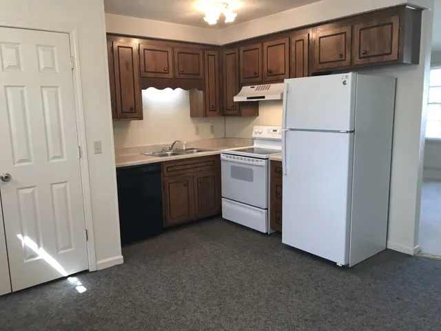 a kitchen with stainless steel appliances granite countertop a refrigerator sink and cabinets