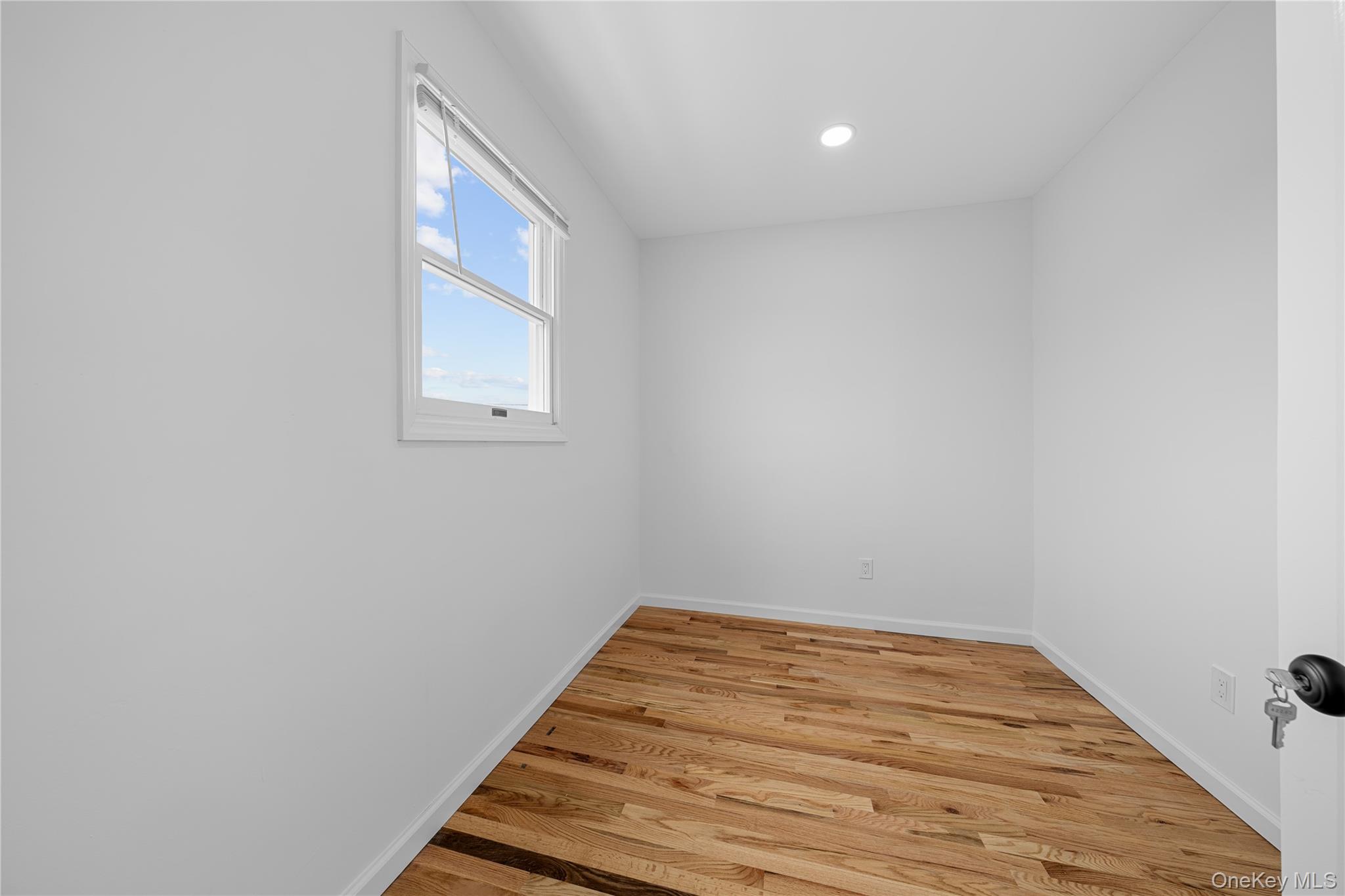 78 Layton Street Freeport, NY 11520 - Photo 14 of 22 a view of a room with wooden floor and a window