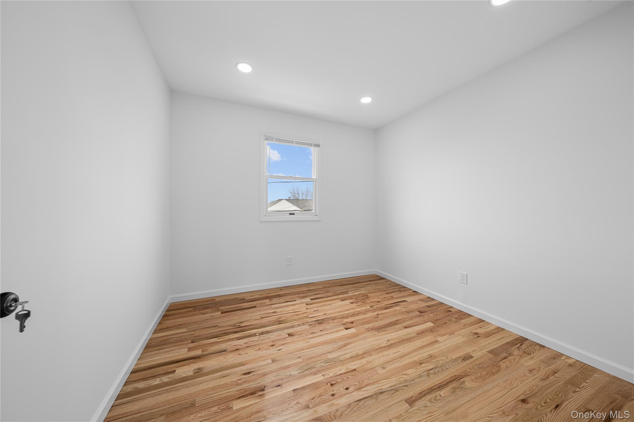 78 Layton Street Freeport, NY 11520 - Photo 15 of 22 a view of room with wooden floor and fan