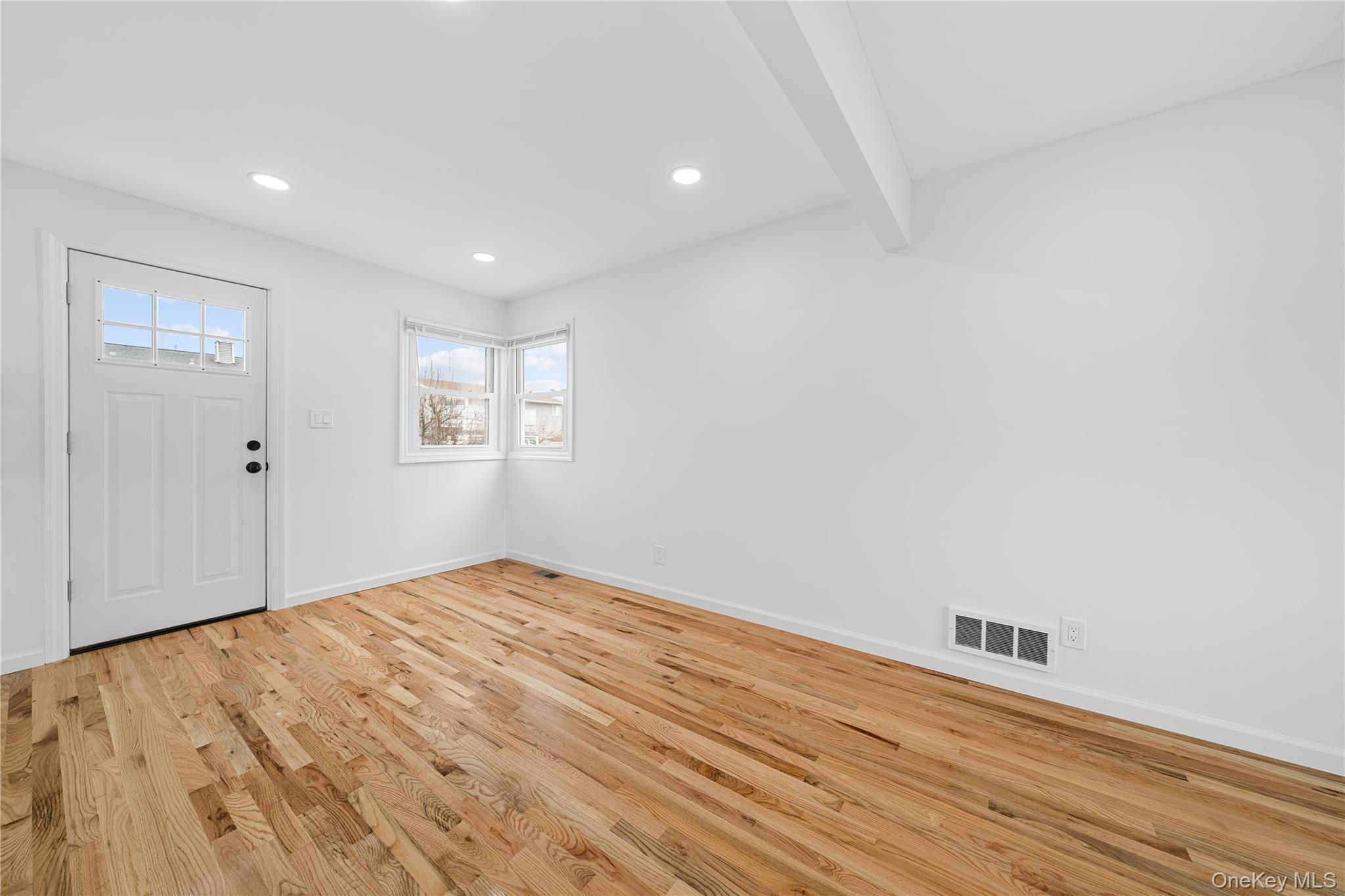 78 Layton Street Freeport, NY 11520 - Photo 20 of 22 a view of empty room with wooden floor and fan
