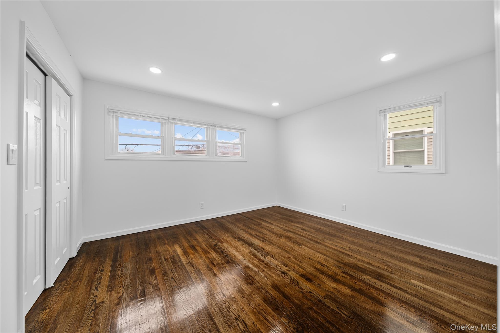 78 Layton Street Freeport, NY 11520 - Photo 21 of 22 a view of empty room with wooden floor and fan