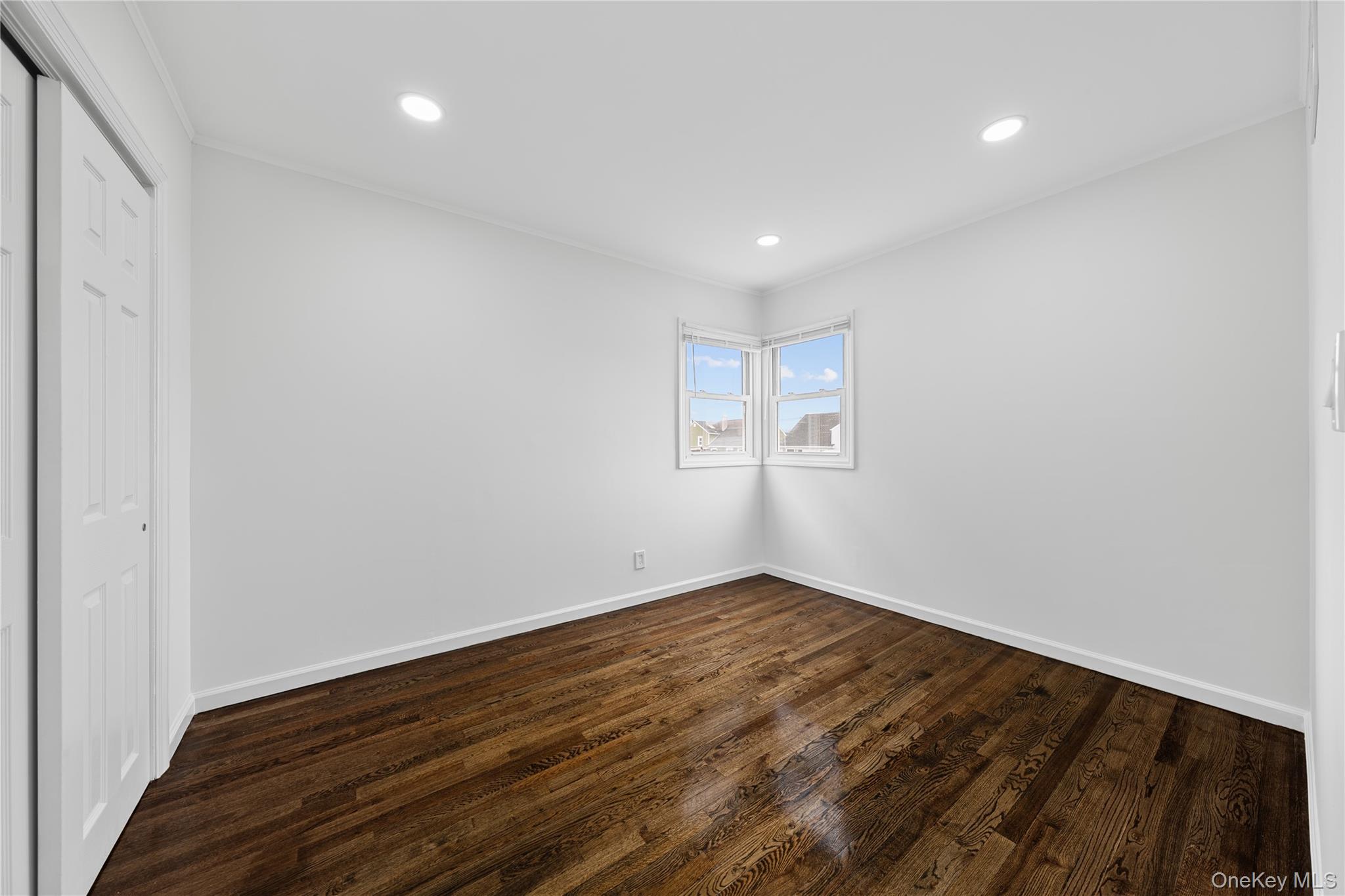 78 Layton Street Freeport, NY 11520 - Photo 22 of 22 a view of room with wooden floor and window