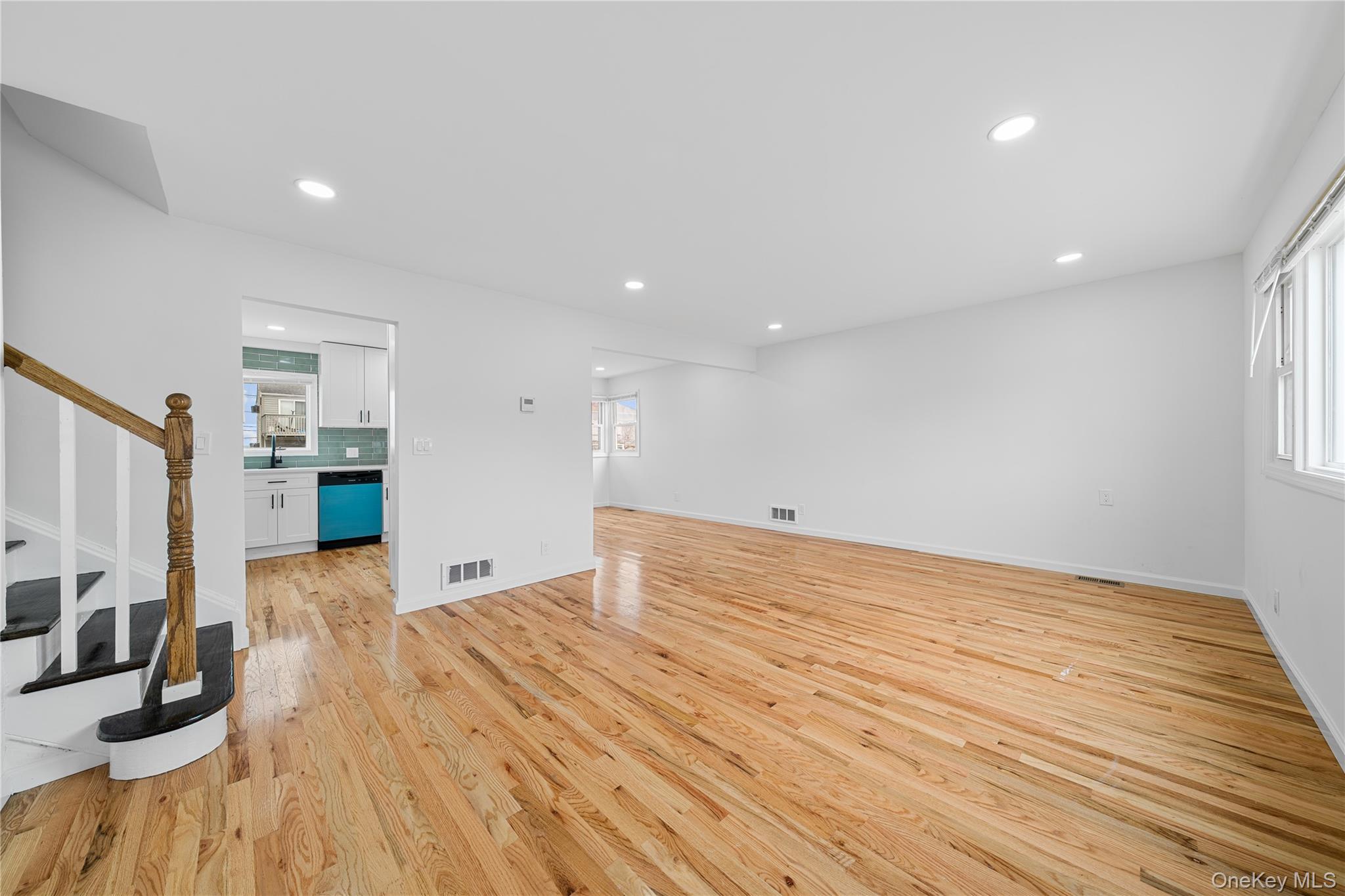 78 Layton Street Freeport, NY 11520 - Photo 7 of 22 a view of a livingroom with wooden floor and kitchen