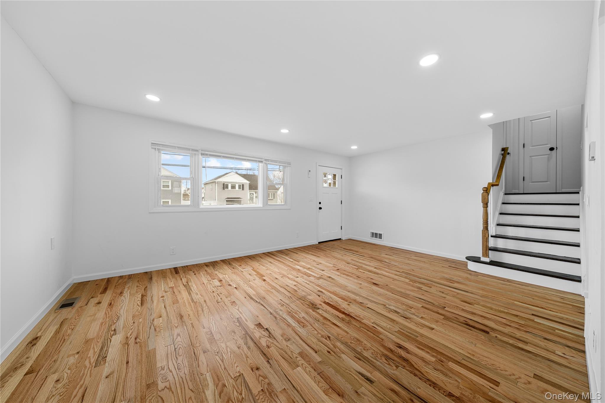 78 Layton Street Freeport, NY 11520 - Photo 8 of 22 a view of empty room with wooden floor and fan