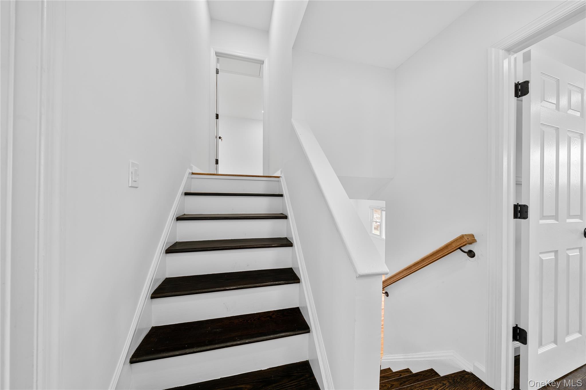78 Layton Street Freeport, NY 11520 - Photo 10 of 22 a view of entryway with wooden floor and stairs
