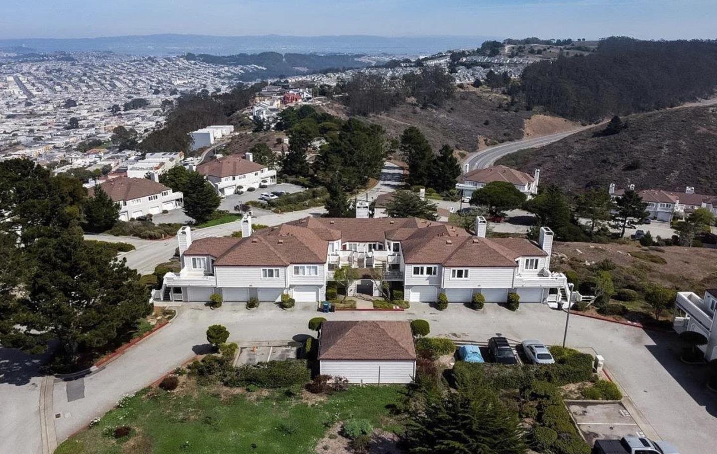 741 Pointe Pacific Drive, Unit 10 Daly City, CA 94014 - Photo 1 of 24 an aerial view of multiple houses with a yard