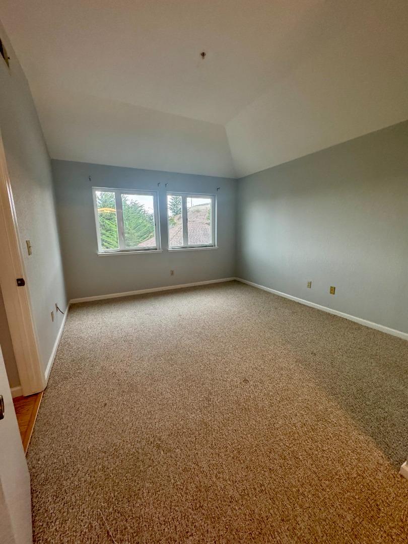 741 Pointe Pacific Drive, Unit 10 Daly City, CA 94014 - Photo 12 of 24 an empty room with windows and entrance