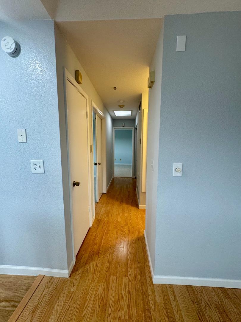 741 Pointe Pacific Drive, Unit 10 Daly City, CA 94014 - Photo 19 of 24 a view of a hallway with wooden floor and staircase