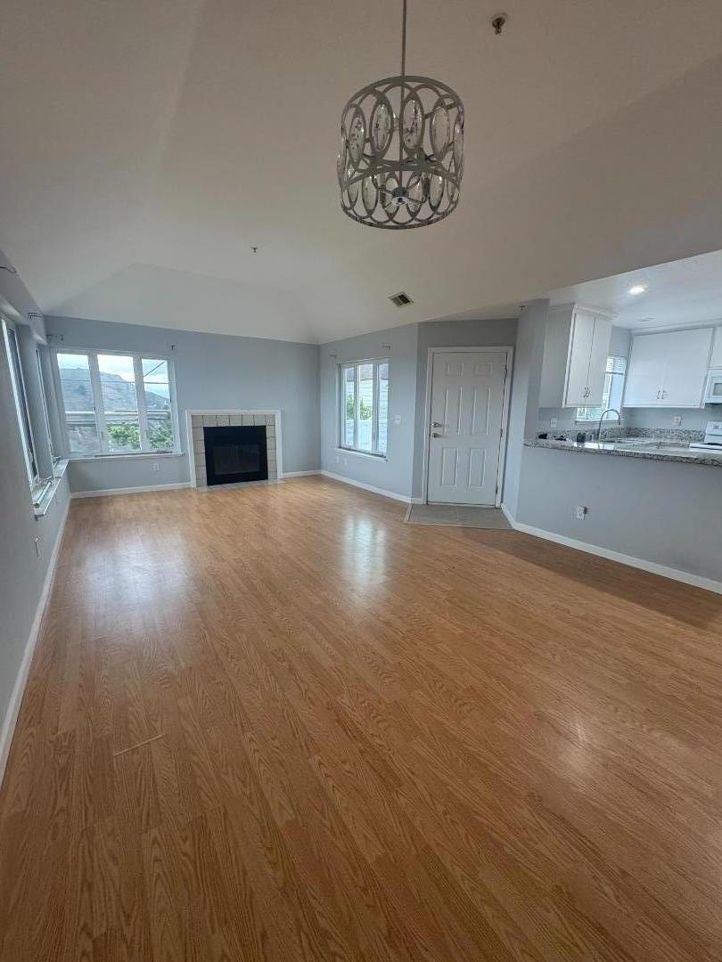 741 Pointe Pacific Drive, Unit 10 Daly City, CA 94014 - Photo 3 of 24 a view of an empty room with a window and wooden floor