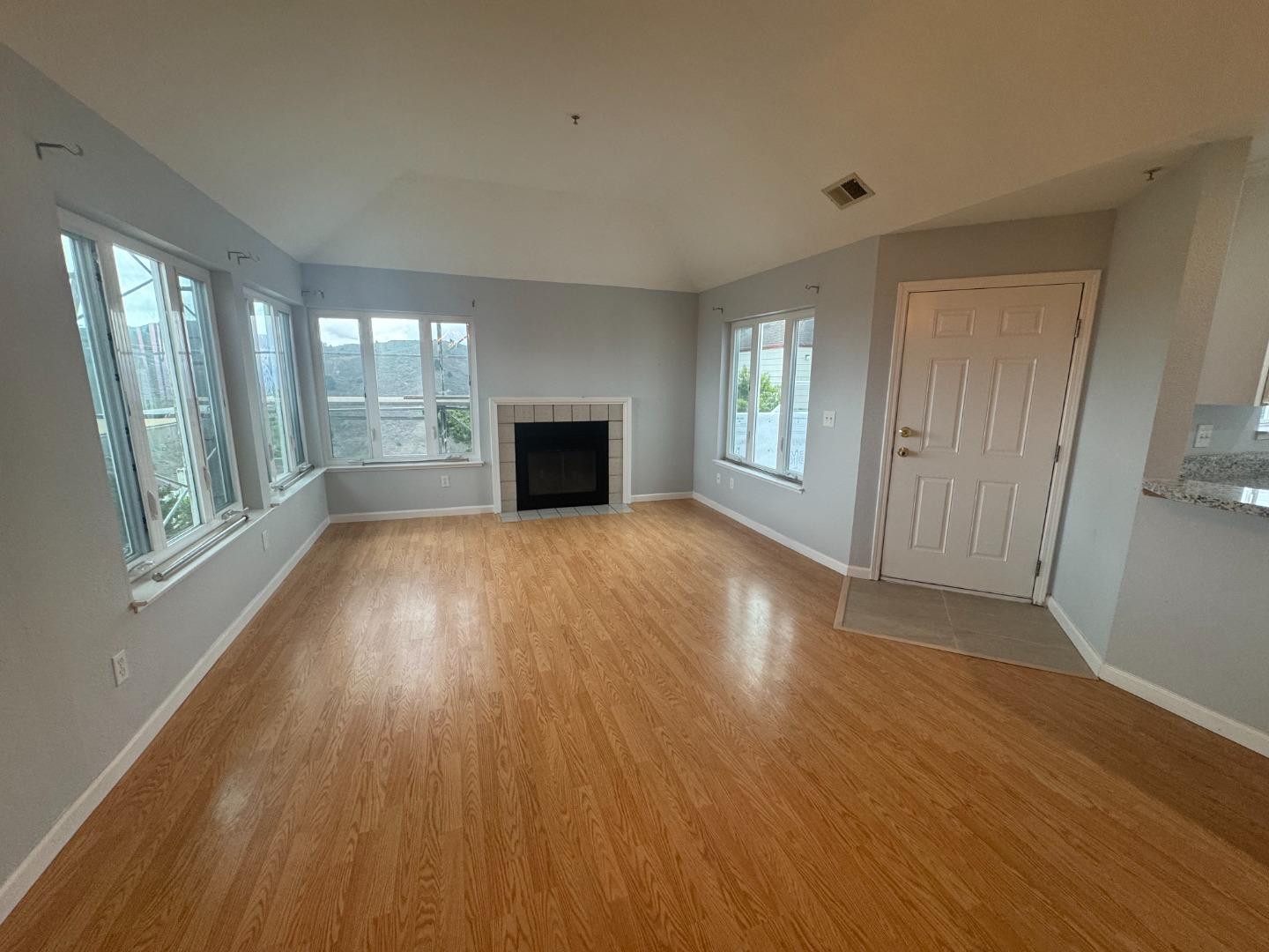 741 Pointe Pacific Drive, Unit 10 Daly City, CA 94014 - Photo 4 of 24 a view of empty room with wooden floor and fan