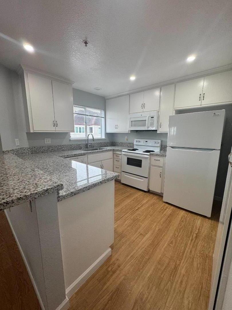 741 Pointe Pacific Drive, Unit 10 Daly City, CA 94014 - Photo 5 of 24 a kitchen with stainless steel appliances granite countertop refrigerator sink and cabinets