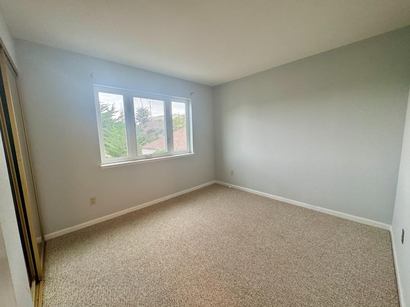 741 Pointe Pacific Drive, Unit 10 Daly City, CA 94014 - Photo 10 of 24 an empty room with windows