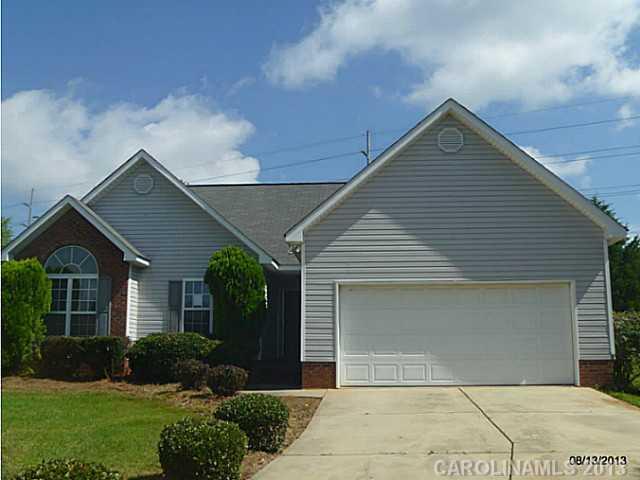 2214 Dawn Ridge, Unit 50 Monroe, NC 28110 - Photo 1 of 16 a front view of a house with a yard and garage