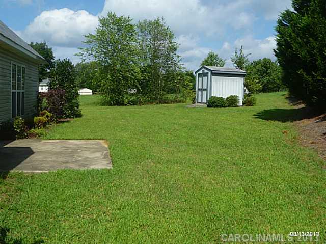 2214 Dawn Ridge, Unit 50 Monroe, NC 28110 - Photo 4 of 16 a front view of a house with a garden and yard