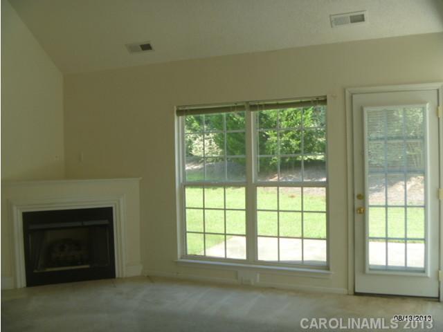 2214 Dawn Ridge, Unit 50 Monroe, NC 28110 - Photo 5 of 16 a view of an empty room with a fireplace and a window