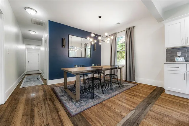 a view of a dining room with furniture and wooden floor