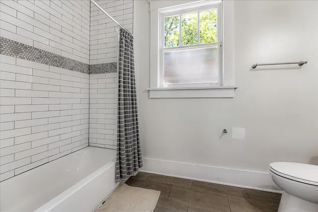 a bathroom with a bathtub and window