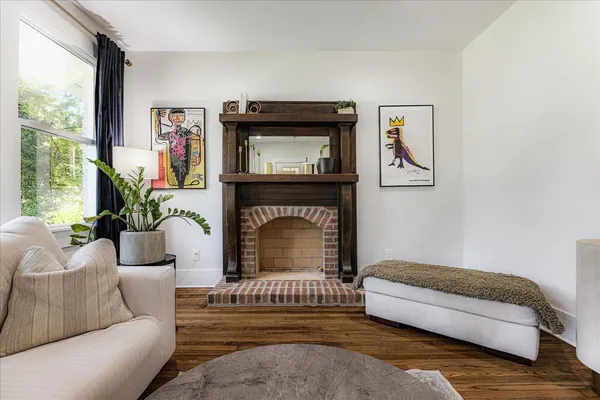 a living room with furniture and a fireplace
