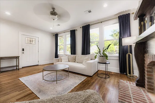 a living room with furniture a large window and a rug