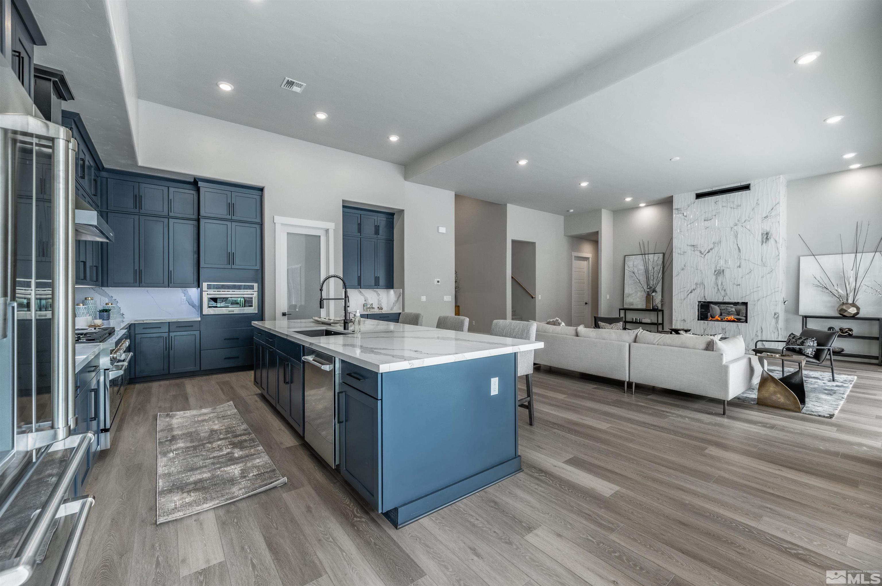 1592 River Hill Way, Unit HOMESITE 16 Reno, NV 89523 - Photo 16 of 35 a large kitchen with stainless steel appliances kitchen island granite countertop a large counter top and stove