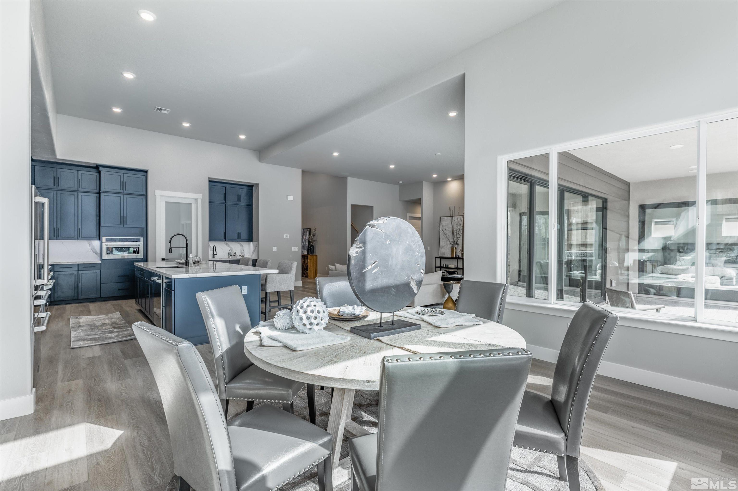 1592 River Hill Way, Unit HOMESITE 16 Reno, NV 89523 - Photo 18 of 35 a dining room with stainless steel appliances kitchen island a table and chairs