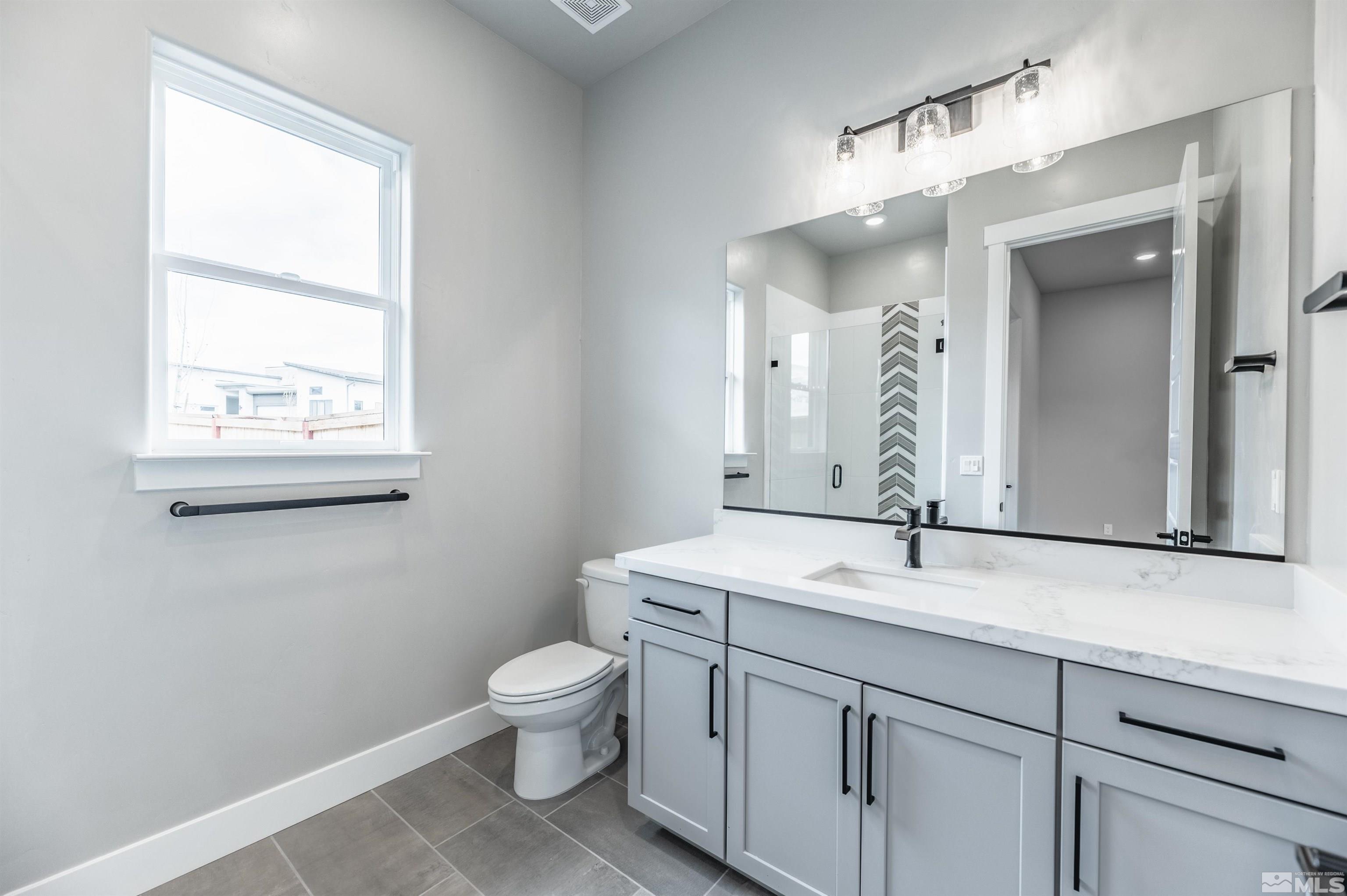 1592 River Hill Way, Unit HOMESITE 16 Reno, NV 89523 - Photo 24 of 35 a bathroom with a toilet sink and mirror