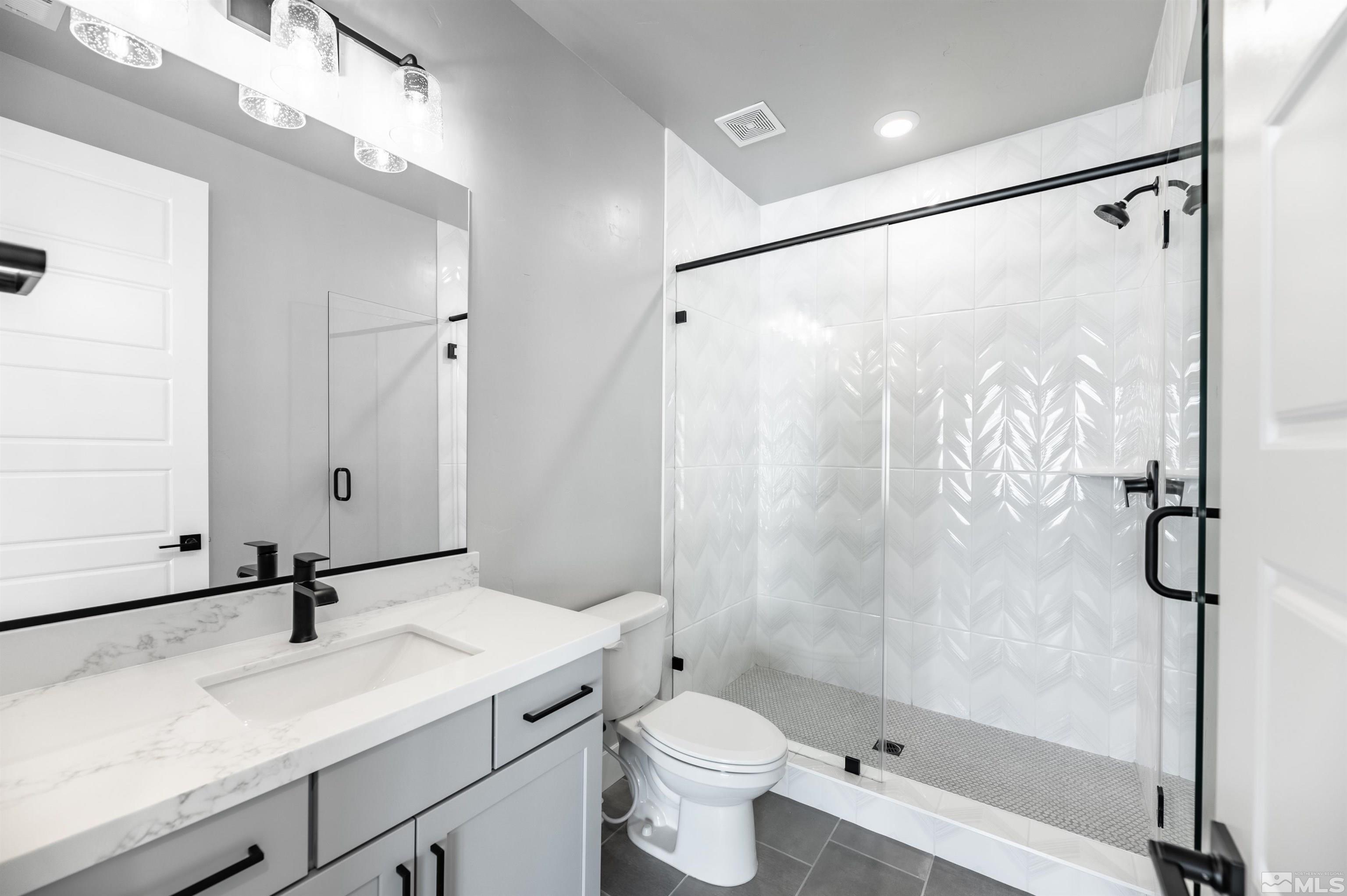 1592 River Hill Way, Unit HOMESITE 16 Reno, NV 89523 - Photo 30 of 35 a bathroom with a shower sink vanity mirror and toilet