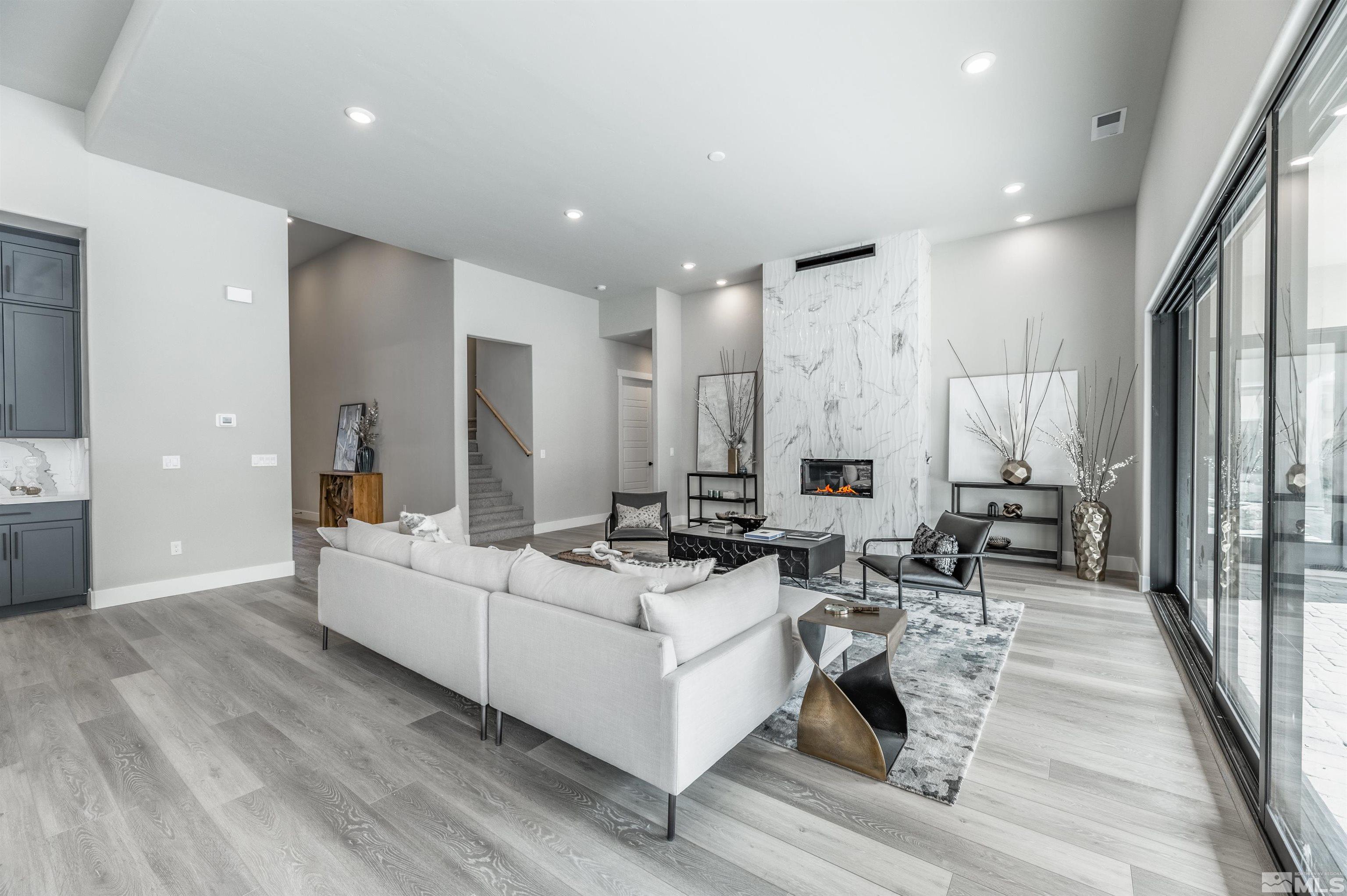 1592 River Hill Way, Unit HOMESITE 16 Reno, NV 89523 - Photo 9 of 35 a living room with furniture a large window and wooden floor