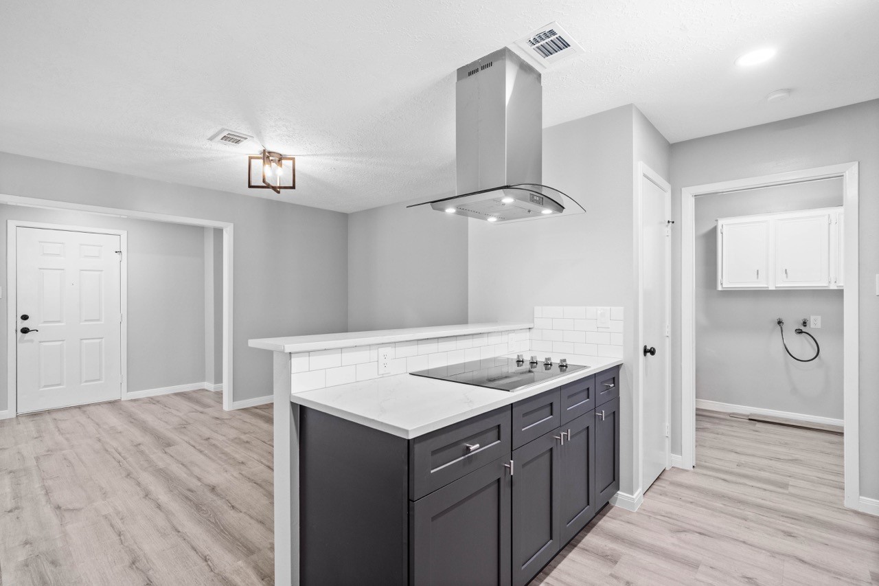 13400 Nicholson Road Conroe, TX 77303 - Photo 13 of 36 With nicely redone subway tile backsplash and electric range cooktop