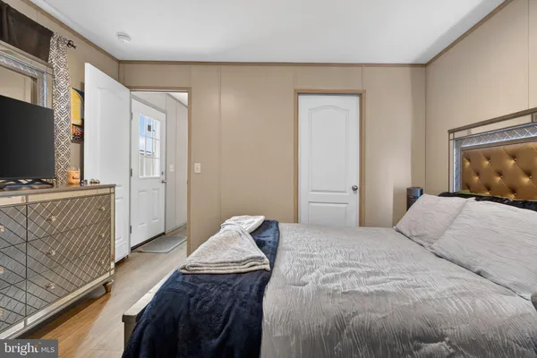 a bedroom with a bed and flat screen tv