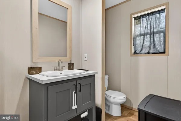 a bathroom with a toilet sink and mirror