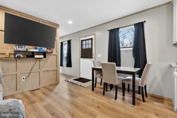 a view of a dining room with furniture and wooden floor