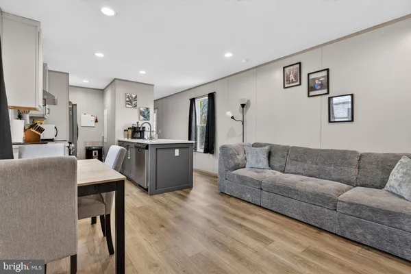 a living room with furniture and kitchen view