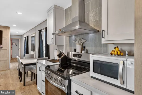 a kitchen with a stove and a table