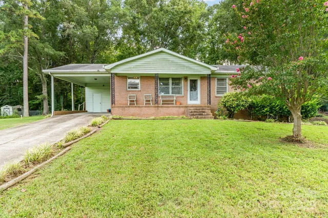 a front view of a house with a yard table and chairs
