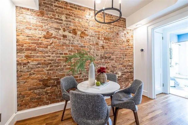 a dining room with furniture and wooden floor