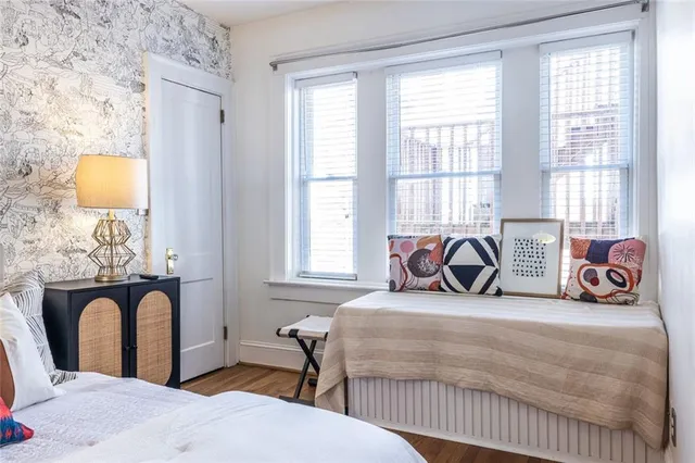 a bedroom with bed and a window